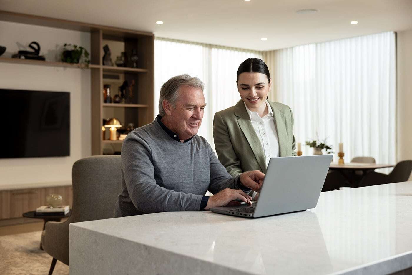 Concierge helps man using computer