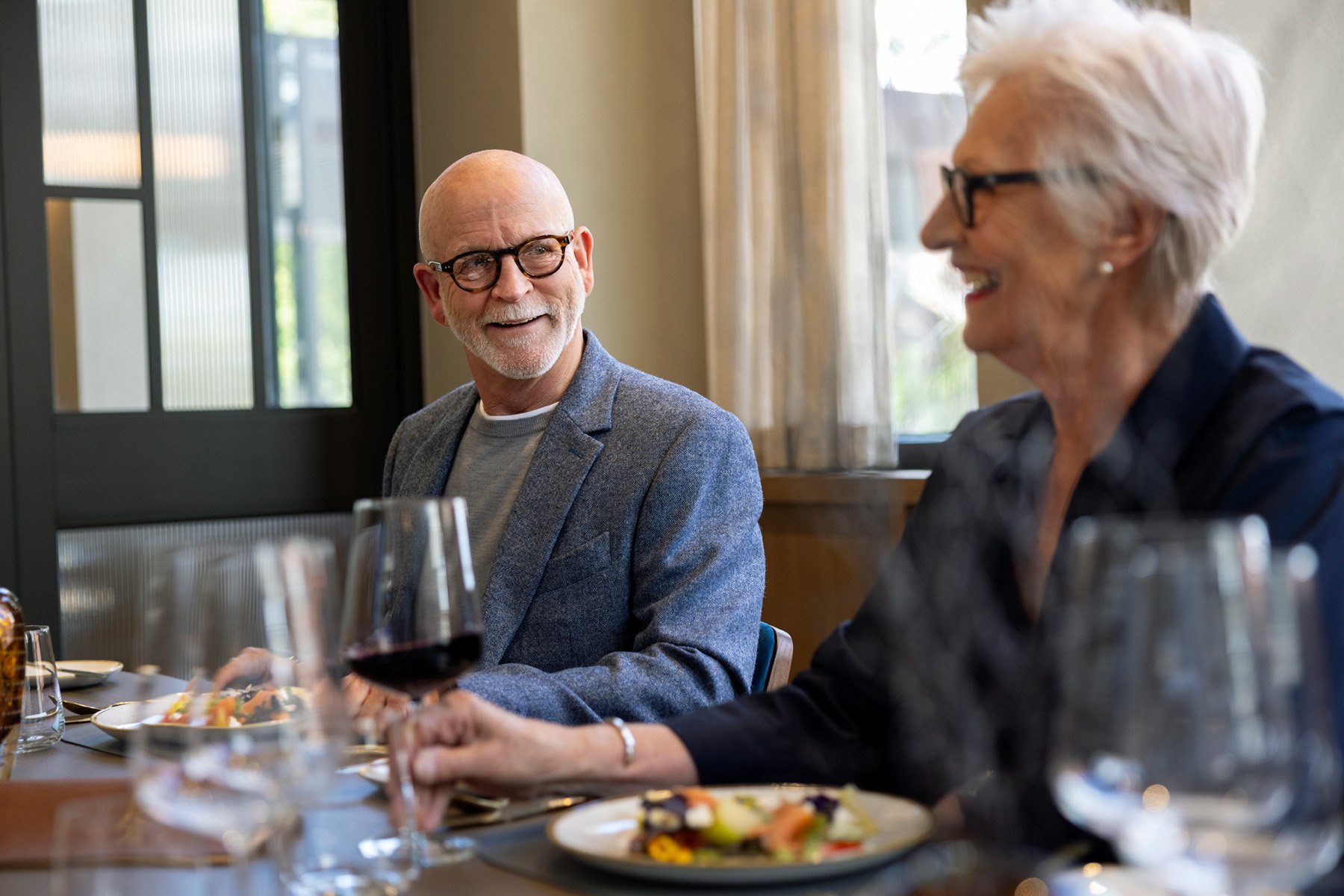 Residents drink wine and socialise in private dining room