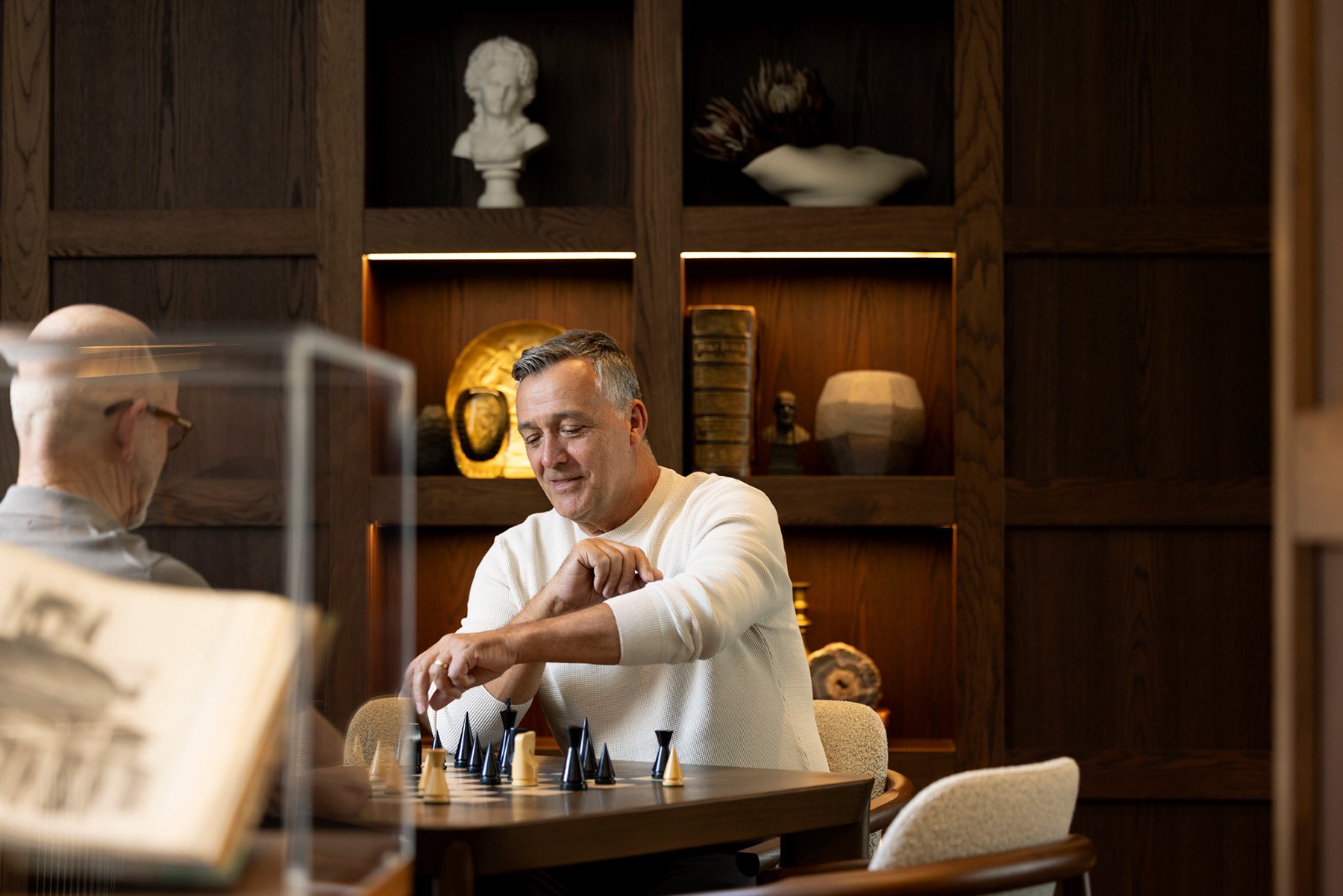 Residents playing chess in St. Clare library