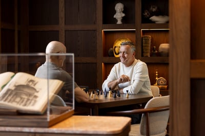 Two men playing chess in St. Clare library