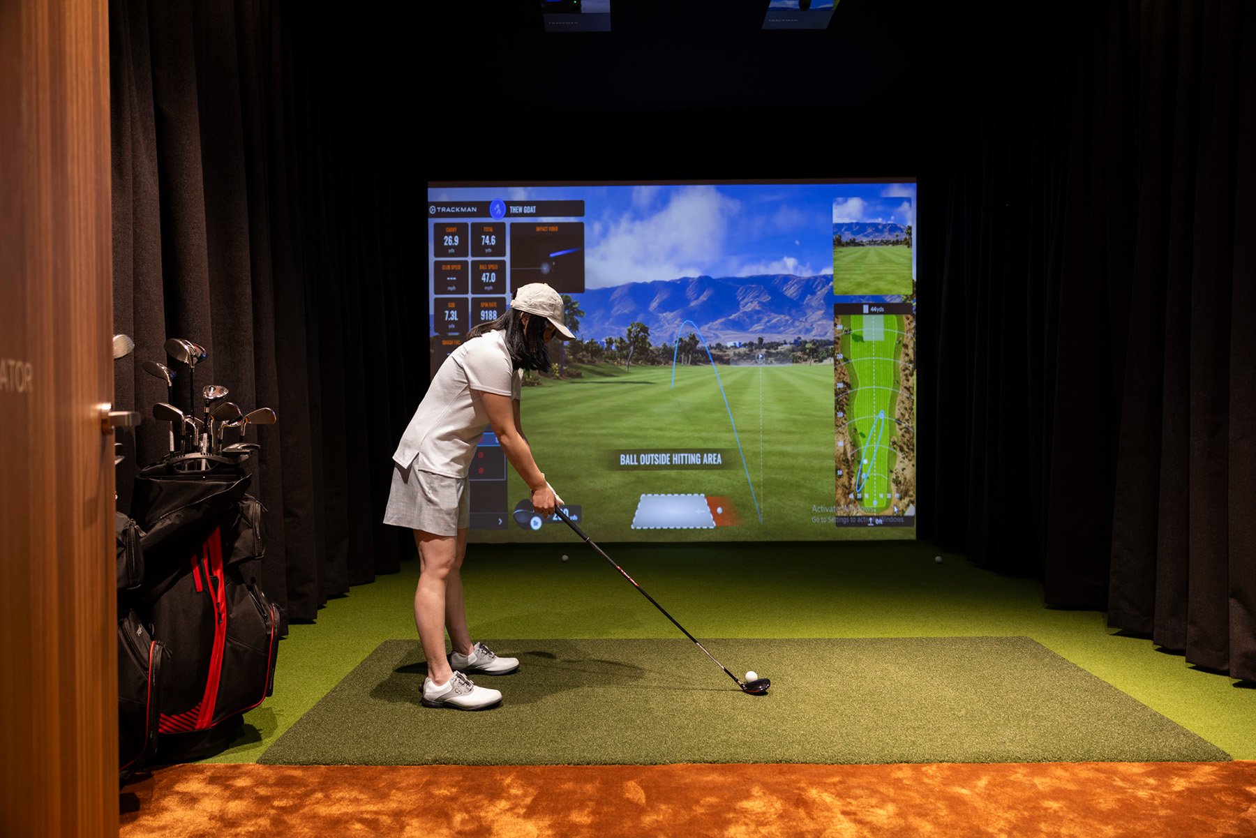 Woman uses St. Clare golf simulator