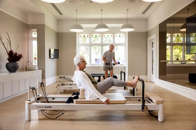 Woman uses reformer machine in St. Clare excercise room